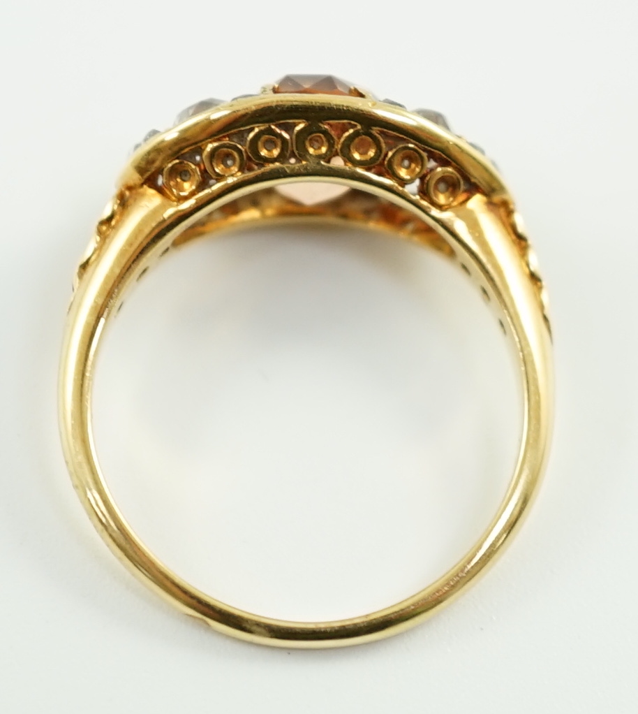 A 1940's gold and single stone oval cut orange topaz set ring, with six stone old mine cut diamond set shoulders